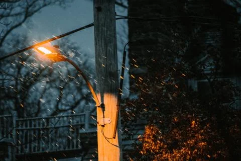 Snow Falling in Front of a Street Light in a Suburban Area Stock Photos