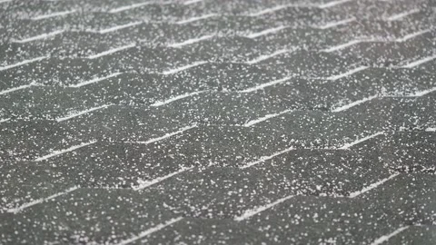 Snow is falling on the green roof tile Stock Footage