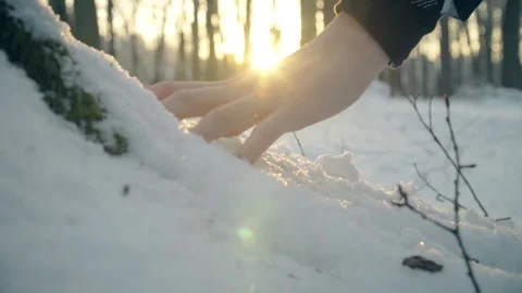 Snow falling from the hand.  The hand takes cold snow 스톡 동영상 79735609