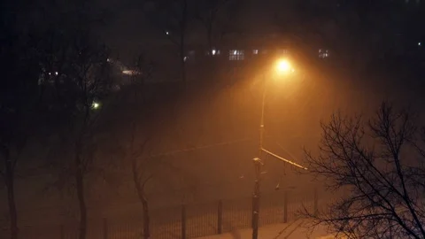 Snow falling heavily in the dim light of a streetlight on the frosty night. Stock Footage 102141683