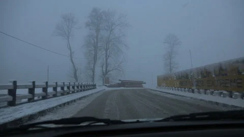 Snow Falling On Highway Road, View Inside Vehicle Through The Wet Car Glass. Stock Footage 111746417