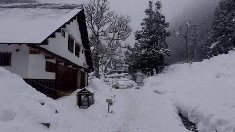 Snow Falling in a Mountain Village in Nagano, Japan Stock Footage 302971663