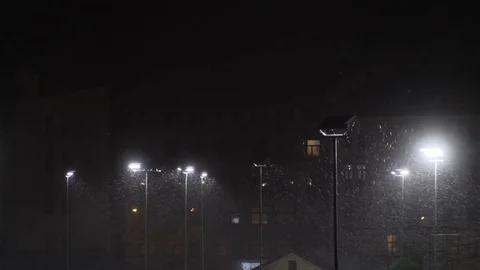 Snow falling at night shot in slow motion. winter season bad weather storm Stock Footage 81720252