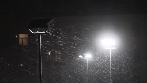 Snow falling at night shot in slow motion. winter season bad weather storm Stock Footage 81720299