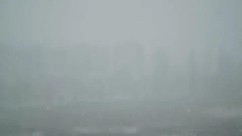 Snow is falling outside the window. Water droplets on the window pane. 스톡 동영상 325984961