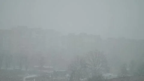 Snow is falling outside the window. Water droplets on the window pane. Видео 325984966