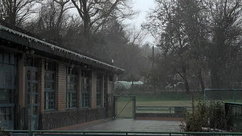 Snow Falling Over an Abandoned School Building Stock Footage 331666913