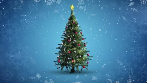 Snow falling over christmas tree spinning against snowflakes on blue background Stock Footage 162931537