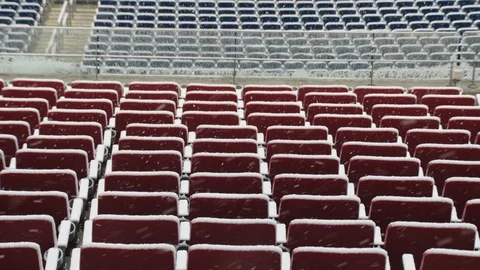 Snow falling over empty seats in stadium Stock Footage 104773988