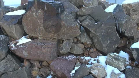 Snow falling over the rock Stock Footage 11415819