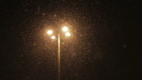Snow falling over a street lantern at night Stock Footage 143736162