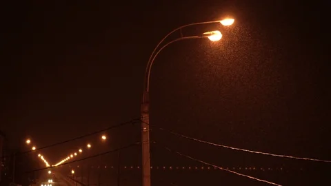 Snow is falling over warm light of street lamp Stock Footage 87755567