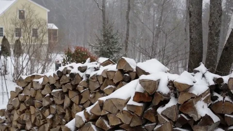 Snow falling on a pile of firewood Stock Footage 73025643