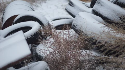 Snow Falling on Pile of Tires Stock Footage 210981089