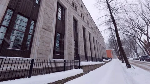 Snow falling on quiet winter city street with trees Stock Footage 323972410