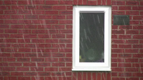 Snow falling on red brick background with white framed window Stock Footage 35055239