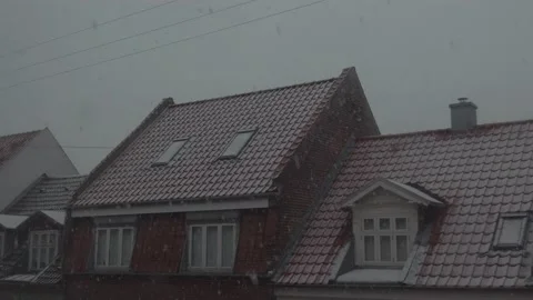 Snow falling on red tile rooftops Stock Footage 170937380