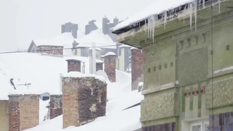Snow falling on rooftops with brick chim... | Stock Video | Pond5