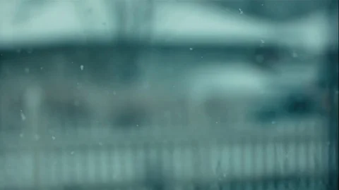 Snow Falling in Slow Motion Against White Fence Stock Footage 73337674