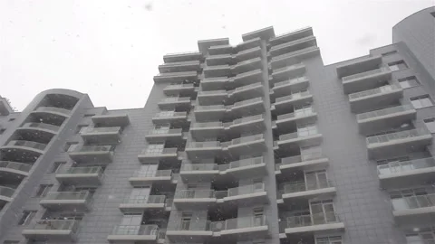 Snow is falling in slow motion and city building Stock Footage 145764156