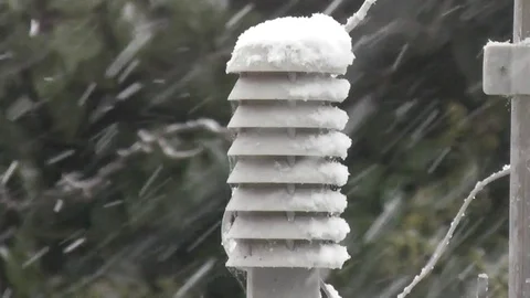 Snow falling on a temperature sensor Stock Footage 92480566