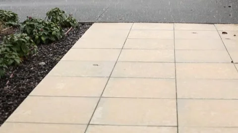Snow falling on tiles then pan up to golf course Stock Footage 52360748