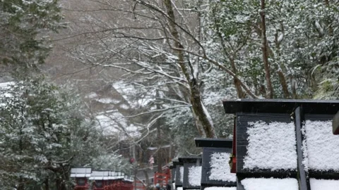 Snow falling on the traditonal wooden lantern along rocky stair pathway in .. Stock Footage 275670735