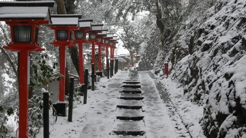 Snow falling on the traditonal wooden lantern along rocky stair pathway in .. Stock Footage 283054675