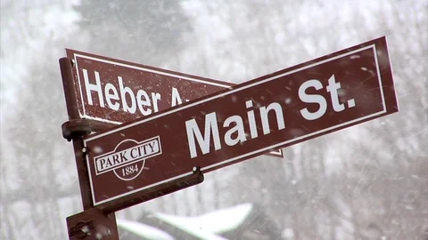 Snow falling on traffic sign on Main Street, Park City, Utah. Video stock 98005488
