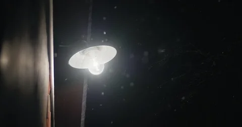 Snow Falling Under Glowing Garage Light at Night Stock Footage 86221969