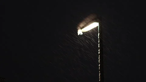 Snow Falling Under Streetlight at Night – Moody Winter Atmosphere Stock Footage 324871699