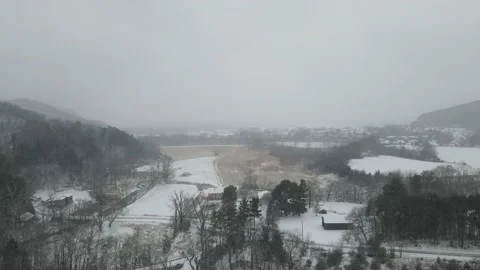 Snow falling in valley in Wisconsin. Open field with historic  mill building. Stock Footage 166263091