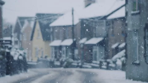 Snow falling in village in slow motion Stock Footage