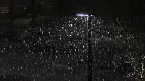 Snow falling visable in the beam from a streetlight Stock Footage 89110296