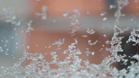 Snow is falling on the window glass, flowing down. Stock Footage 170642517