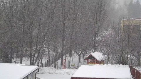 Snow falling in the yard Stock Footage 83647609