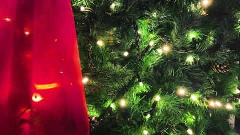 Snow falls against the backdrop of a building decorated with red fabric. Video stock 295832513