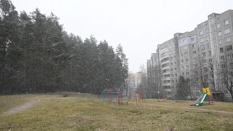 Snow falls against the background of an empty Playground, an unexpected snowfall Stock Footage 127574131