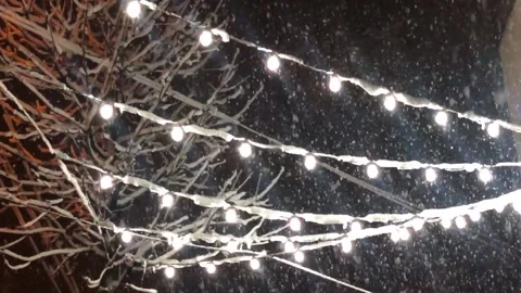 Snow falls on the background of a garland. Snow falls on the background of Video stock 201528385