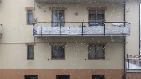 The snow falls between the buildings Stock-Footage 148567312
