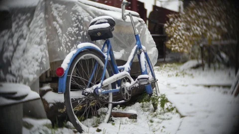 Snow falls on bicycle Stock Footage 70837704
