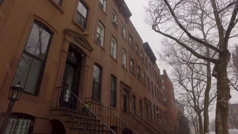Snow falls in front of iconic Brooklyn Brownstones Stock Footage 148037989