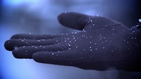Snow falls on a man's gloved hand Stock Footage 58948073