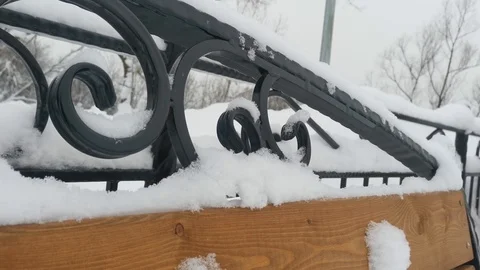 Snow falls on a Park bench Stock Footage 124405951