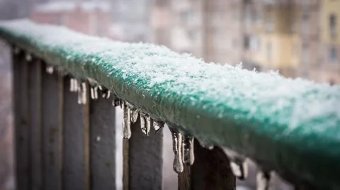 Snow falls on the railing with icicles. Timelapse video 库存影片 58625854