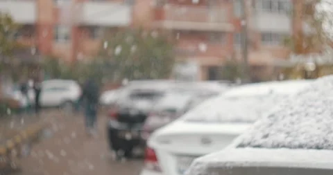SNOW FALLS FROM THE SKY IN THE BACKGROUND A CAR IS STANDING Stock Footage 143752371