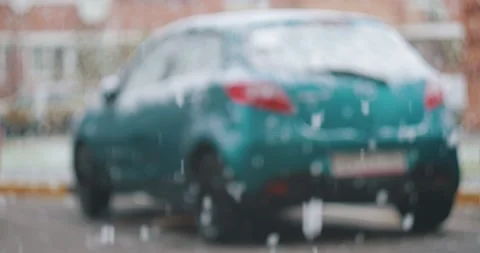 SNOW FALLS FROM THE SKY IN THE BACKGROUND A CAR IS STANDING Stock Footage 143752485