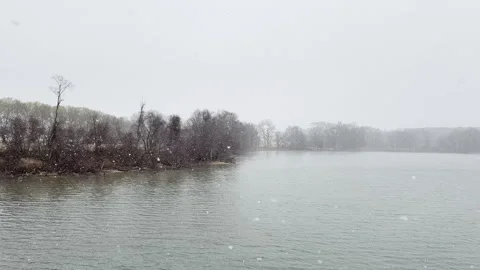 Snow Falls Slowly on River from elevated viewpoint Stockbeeldmateriaal 337579925
