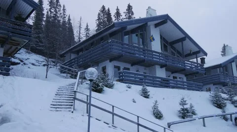 Snow falls on a two-storied house in winter forest, Sweden Vidéo 64921469