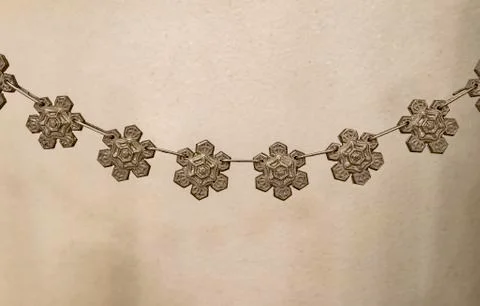 Snow flake symbol in silver pendant Stock Photos